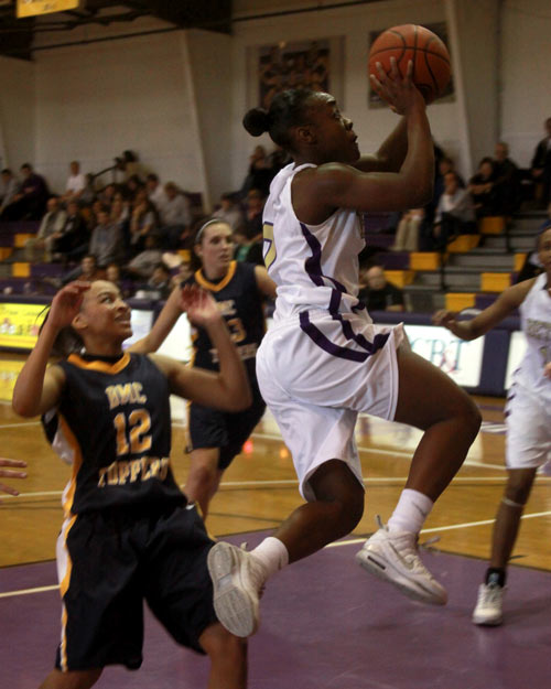 BU's Kashundria Berry glides to the basket in Bethel's win over Blue Mountain. She led all scorers with 24 points.