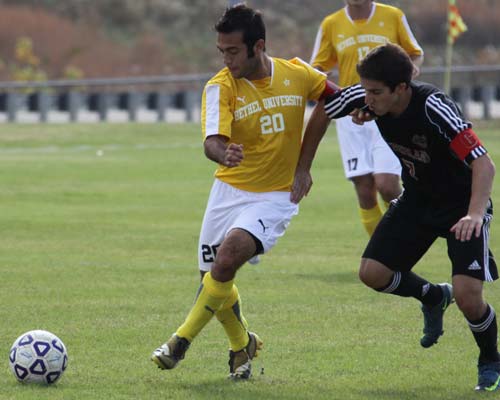 Armando Orozco battles for position.  He scored one of the two goals for the Wildcats.