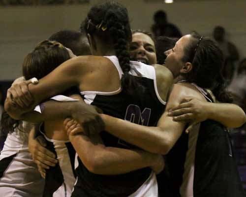 Bethel volleyball players enbrace and celebrate after defeating Freed-Hardeman for the first time in the program's history.