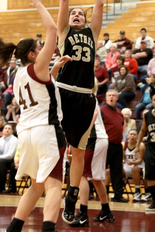 Nina Djokovic works hard in the paint against Jana Cross of Freed-Hardeman; Djokovic led Bethel with 20 points in the loss